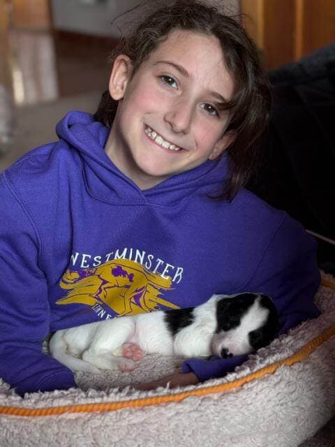 Raven holding her three-week-old Silken Windhound puppy.photo by Leigh Klatzky Alexande