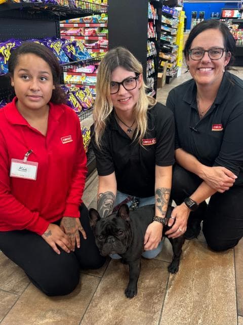 The ladies fan club club shares a moment with Dude at the Circle K.