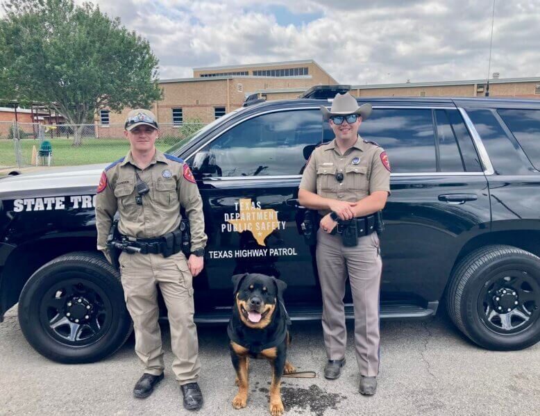 Two policemen with a Therapy Dog named "Axel"