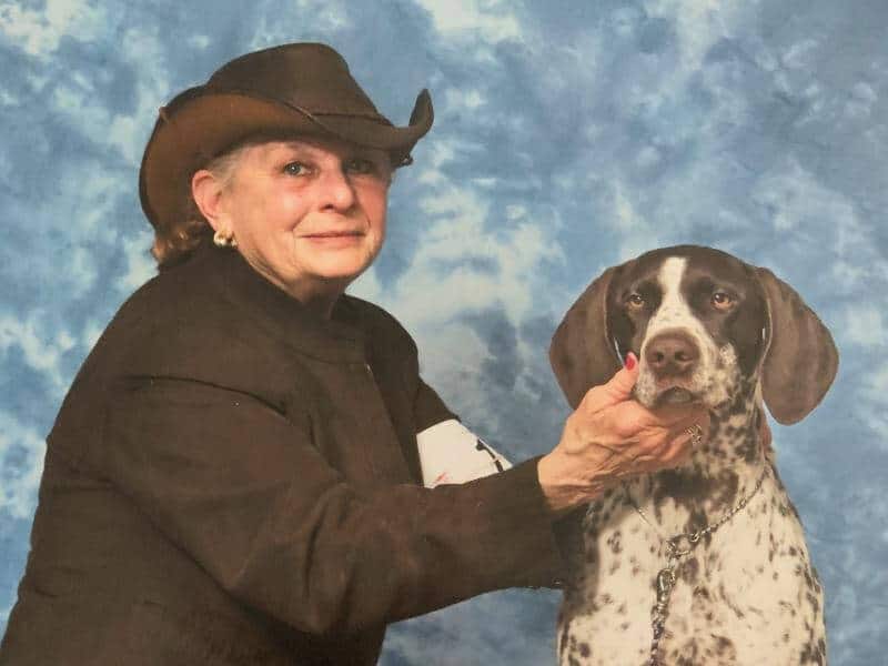 Terry M. DePietro posing with her dog.