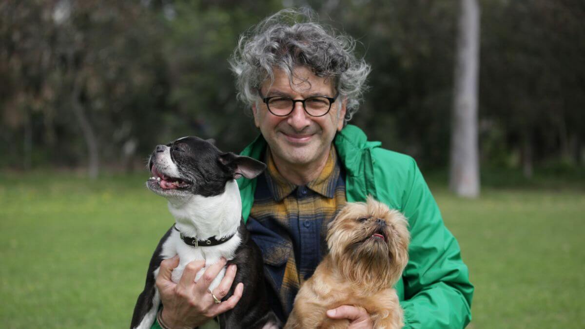 George Sofrondis holding two dogs.