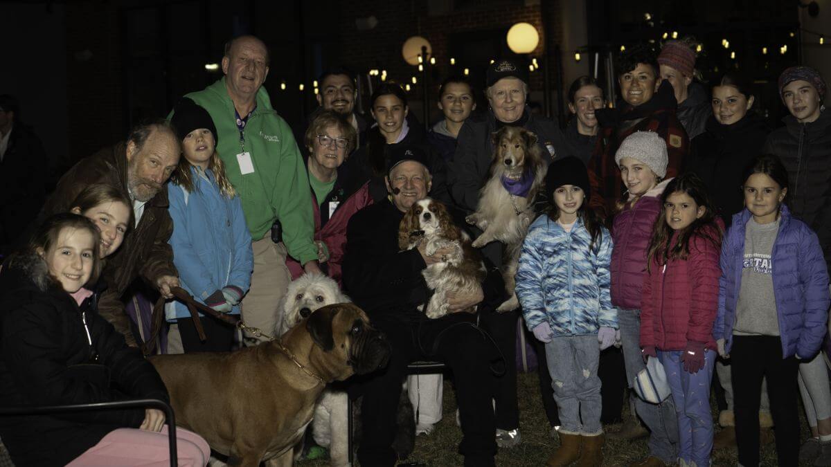 David Frei with True Dat (seated middle) surrounded by attendees at The National Dog Show Agility Dog/Therapy Dog event on Thursday of show week. Rufus, the Bullmastiff on the left, competed in The National Dog Show and is a member of The National Dog Sho