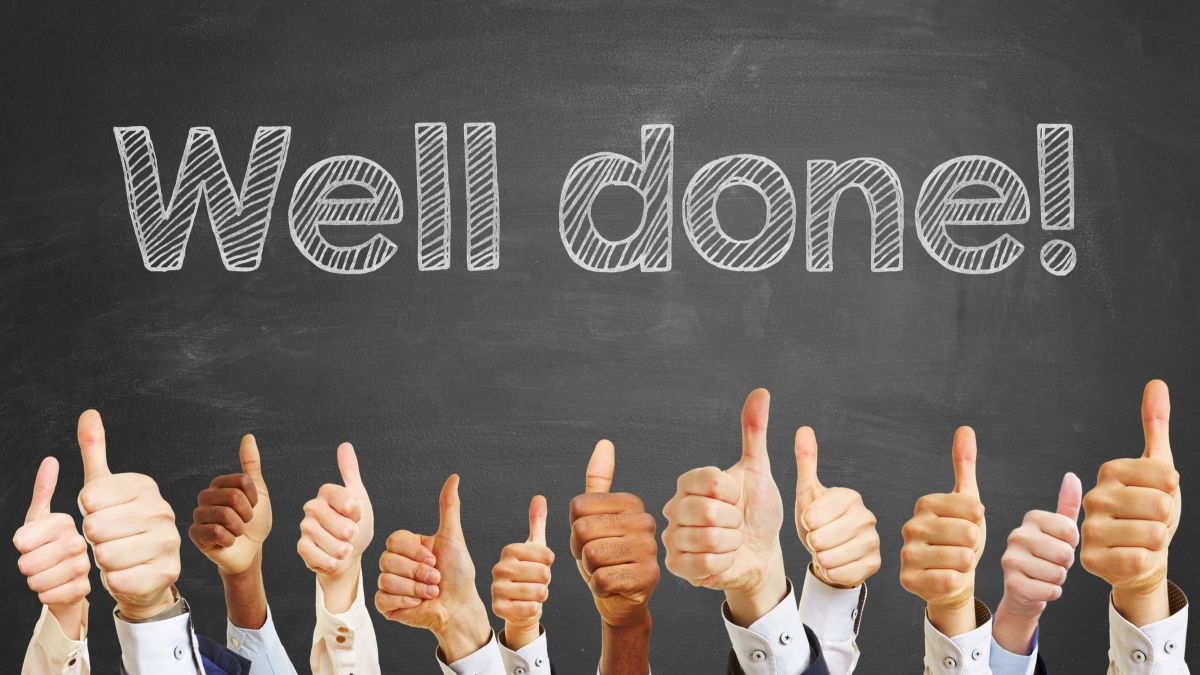 Congratulations slogan "well done" on chalkboard for celebration with thumbs up
