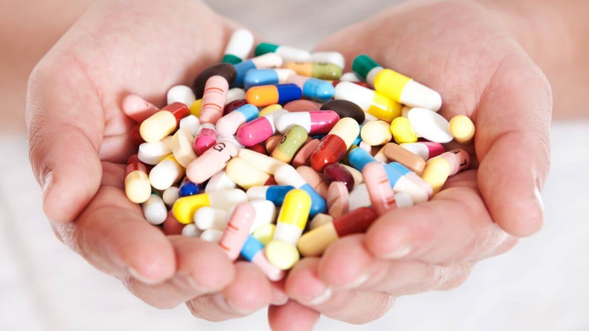 Person holding pharmaceuticals in her hands