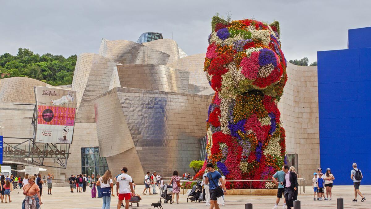 Bilbao, Spain - July 15, 2024: The floral sculpture 'Puppy' - Standing in front of Bilbao s Guggenheim Museum at 43 feet tall, the flower-covered topiary is a symbol of Spain s fifth-largest city