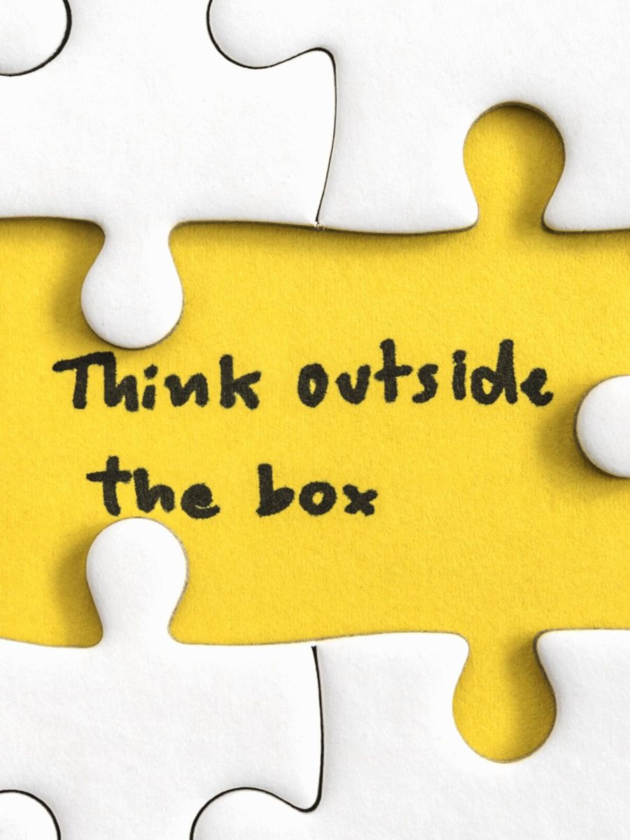 Think outside the box quotes business concept. Jigsaw puzzle piece with two missing and hand writing letters word think outside the box, Quotes business concept