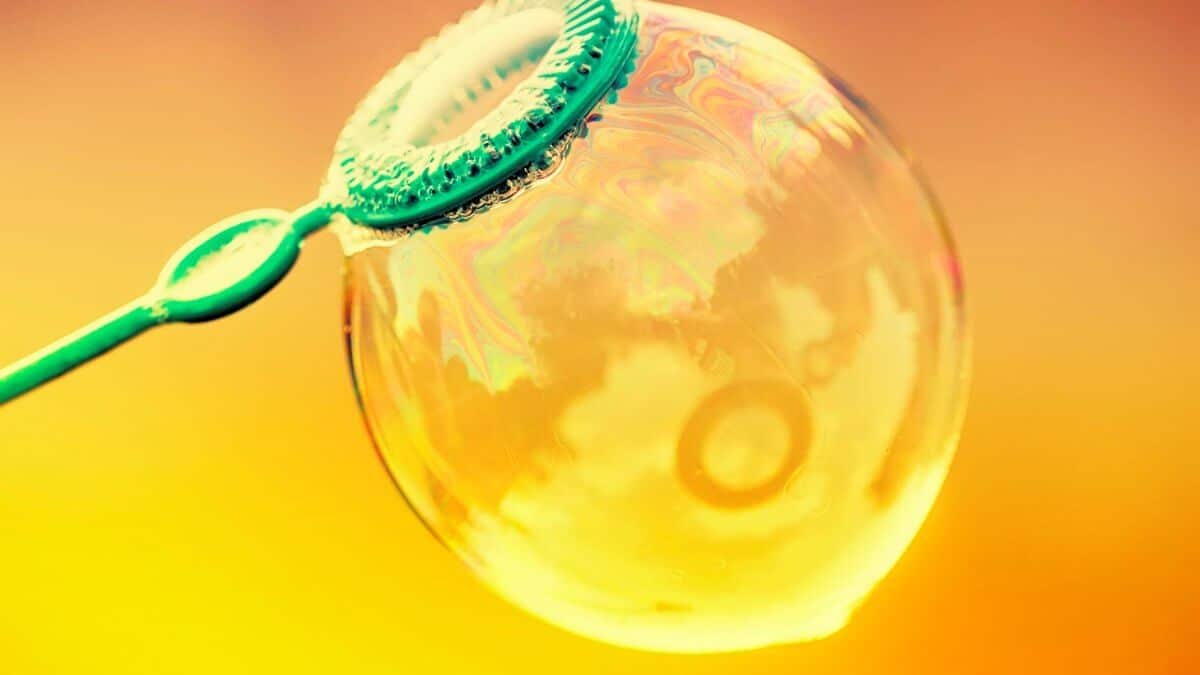 Inflated soap bubble on a bright summer background, selective focus and shallow depth of field
