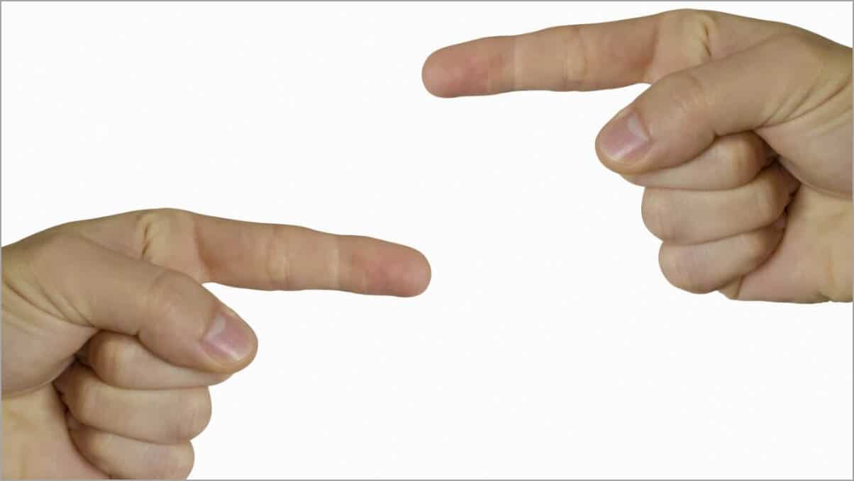 A closeup shot of people pointing fingers at each other on an isolated background