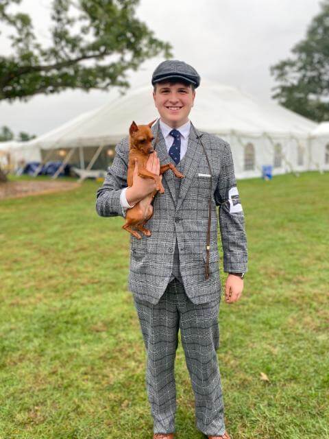A young handler in period attire, ready for the ring.