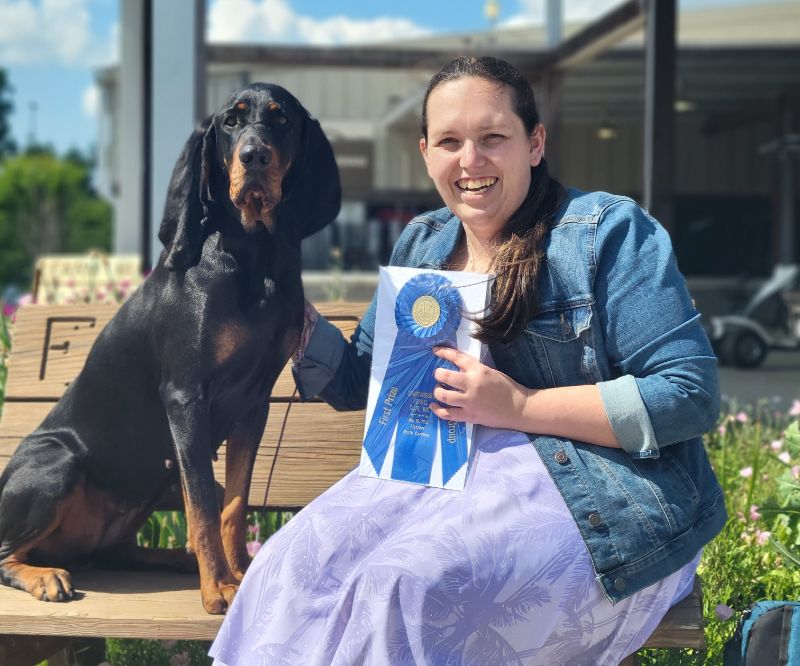Owner Handler Nikkei (Danielle) Lyons with her Black and Tan Coonhound dog