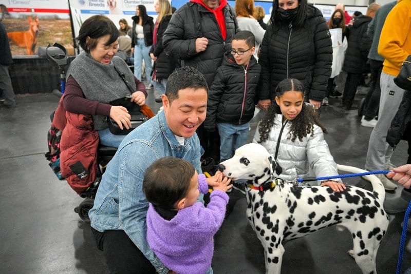 family with a dalmatian at the 2023 akc meet the breeds