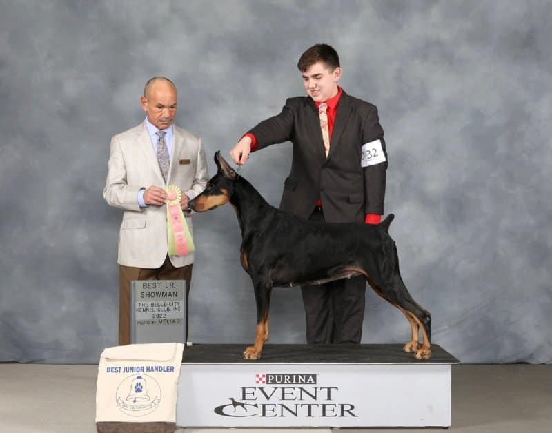 Bryant Janetzke with his doberman at a dog show podium