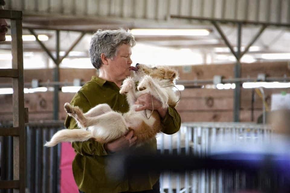 Carolyn Noteman, breeder of DragonFly Hollow Kromfohrlanders, holding her dog in her hands