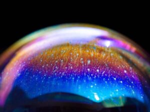 Multicolored rainbow in a bubble. Abstract texture inside of the soap bubble, macro photography.