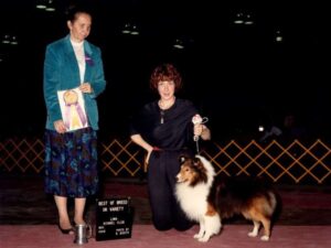 Sulie Greendale-Paveza holding a dog and a medal.