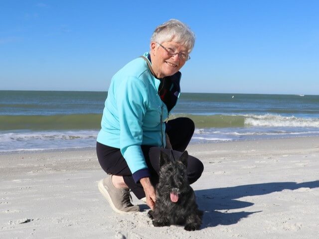 Sandra Anderson with her dog at the beach.