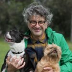 George Sofrondis holding two dogs.