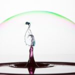Splash of colorful liquid into a bubble with high speed flash