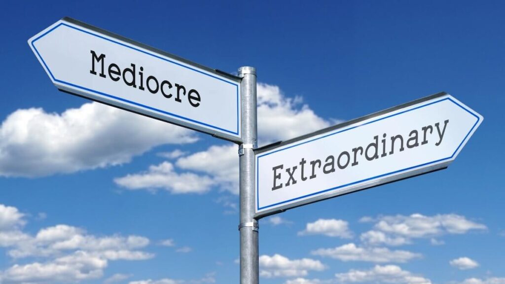 Extraordinary or mediocre - metal signpost with two arrows, sky with clouds in background.
