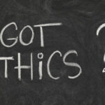 Got ethics? Are you ethical question handwritten with white chalk on blackboard with eraser smudges