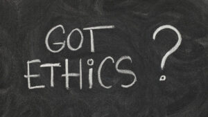 Got ethics? Are you ethical question handwritten with white chalk on blackboard with eraser smudges