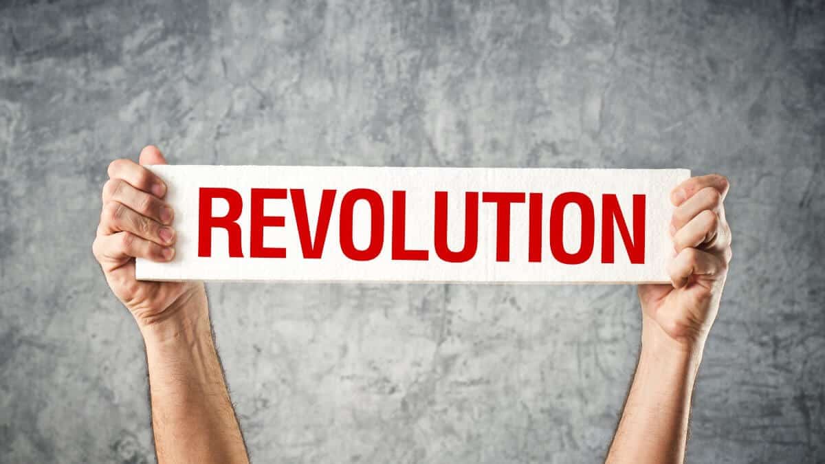 Man holding white banner with revolution title printed on it.