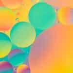 Oil drops on water with colorful gradient background