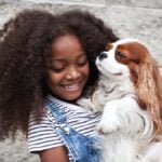 portrait happy african american child holding pet-2025-01-16-12-10-00-utc
