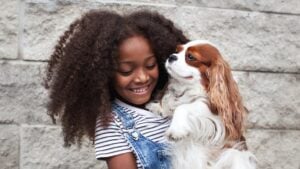 portrait happy african american child holding pet-2025-01-16-12-10-00-utc