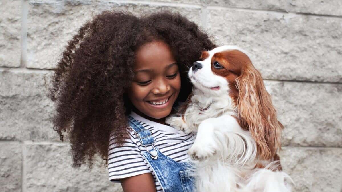 portrait happy african american child holding pet-2025-01-16-12-10-00-utc