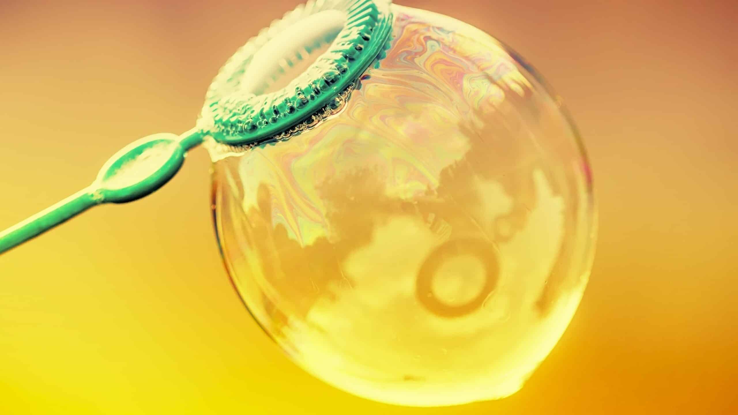 Inflated soap bubble on a bright summer background