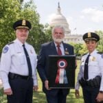 Christopher Sweetwood presenting AKC Distinguished Service Award to U.S. Capitol Police Chief.