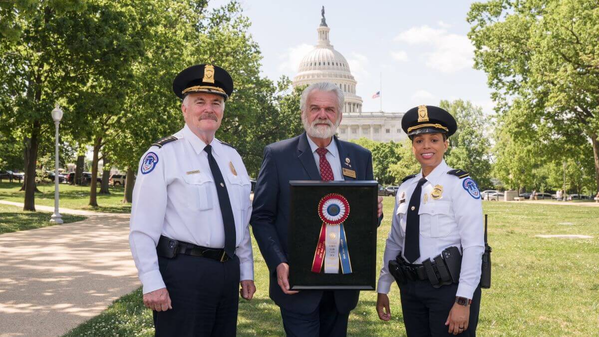 Christopher Sweetwood presenting AKC Distinguished Service Award to U.S. Capitol Police Chief.