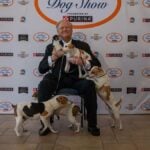 Farmdogs Galore! David Frei revels in the attention of a bevy of Danish-Swedish Farmdogs at the annual National Dog Show press preview in Philadelphia.