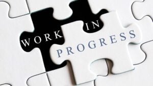 Work in progress text on puzzles background.