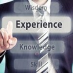 Businessman pressing experience button. Experience concept, toned photo.