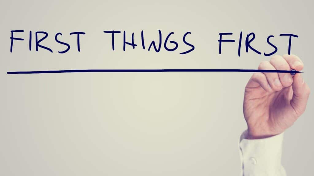 Retro effect concept - First Things First - with a man writing the words on a virtual interface with a marker pen over white with copyspace conceptual of prioritizing tasks.