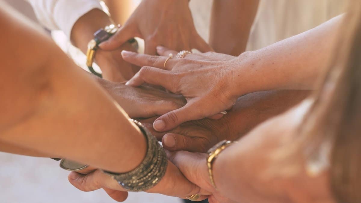 Close up with lot of women hands holding and touching each other for friendship concept.