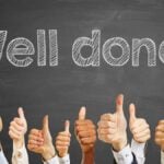 Congratulations slogan "well done" on chalkboard for celebration with thumbs up