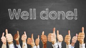 Congratulations slogan "well done" on chalkboard for celebration with thumbs up