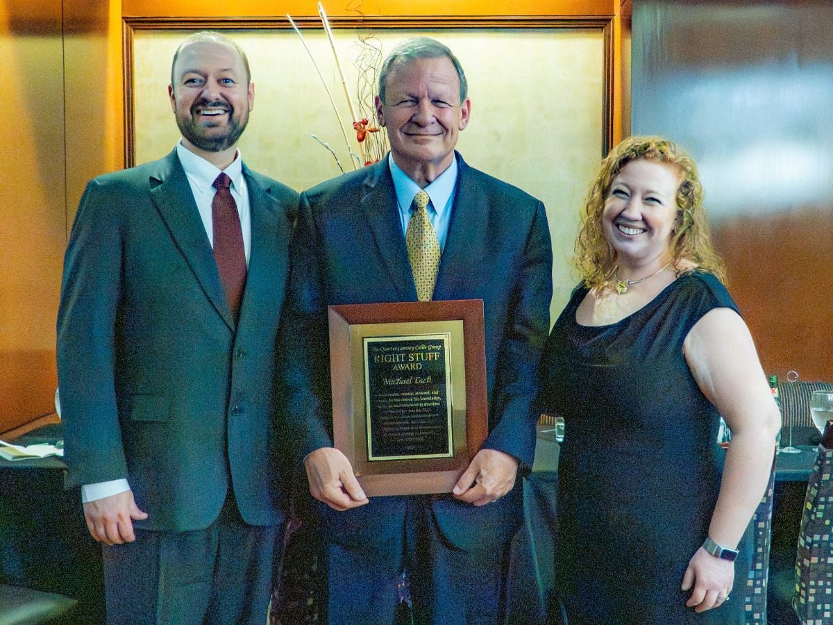 Mike is surrounded by his son, Joe, and daughter, Michelle Esch Brooks, who spoke to honor their dad.