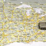 Across America. Model sedan on map of US highways.