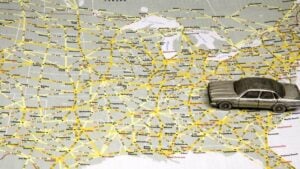 Model sedan on map of US highways.