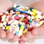 Person holding pharmaceuticals in her hands