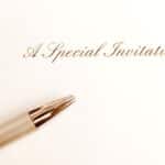 A special invitation card. you are invited. You re invited! A photograph showing a card with the words Special Invitation printed on it, taken with a golden pen beside it. Simple and elegant composition for the concept of writing a special invite. Vertical format photo.